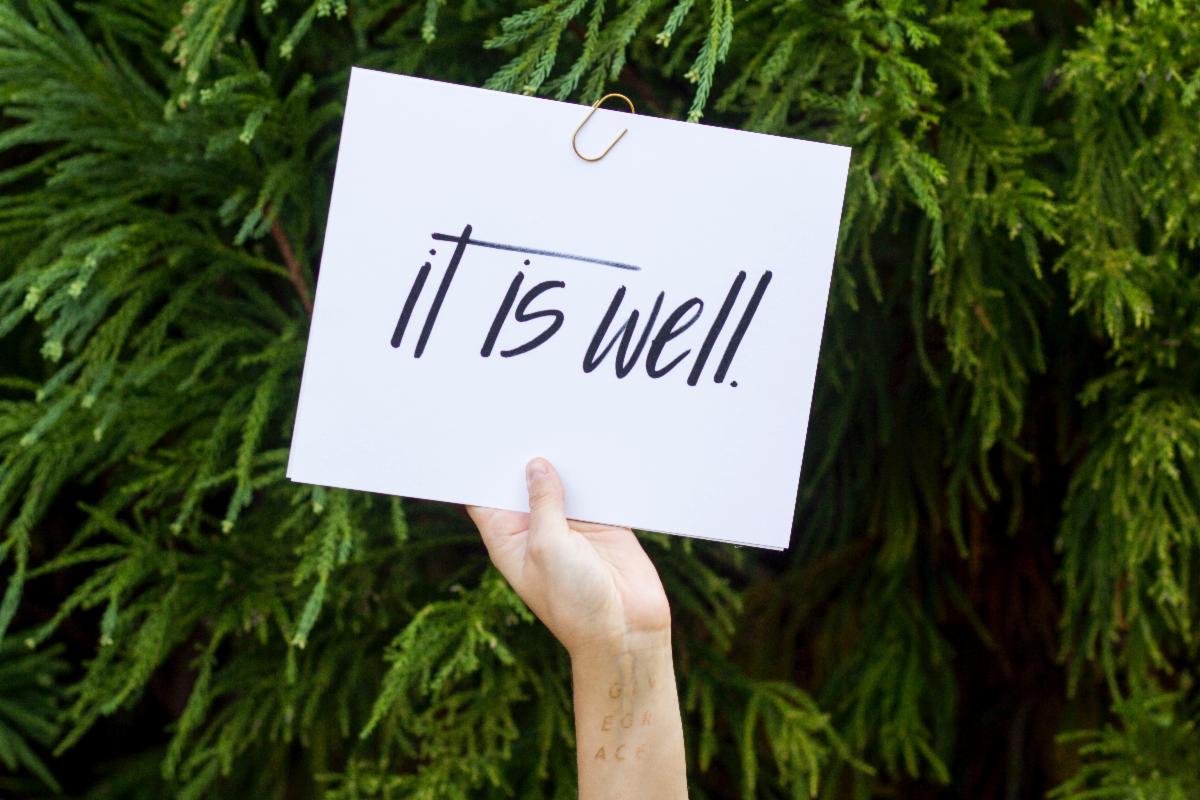 placard with text "it is well"